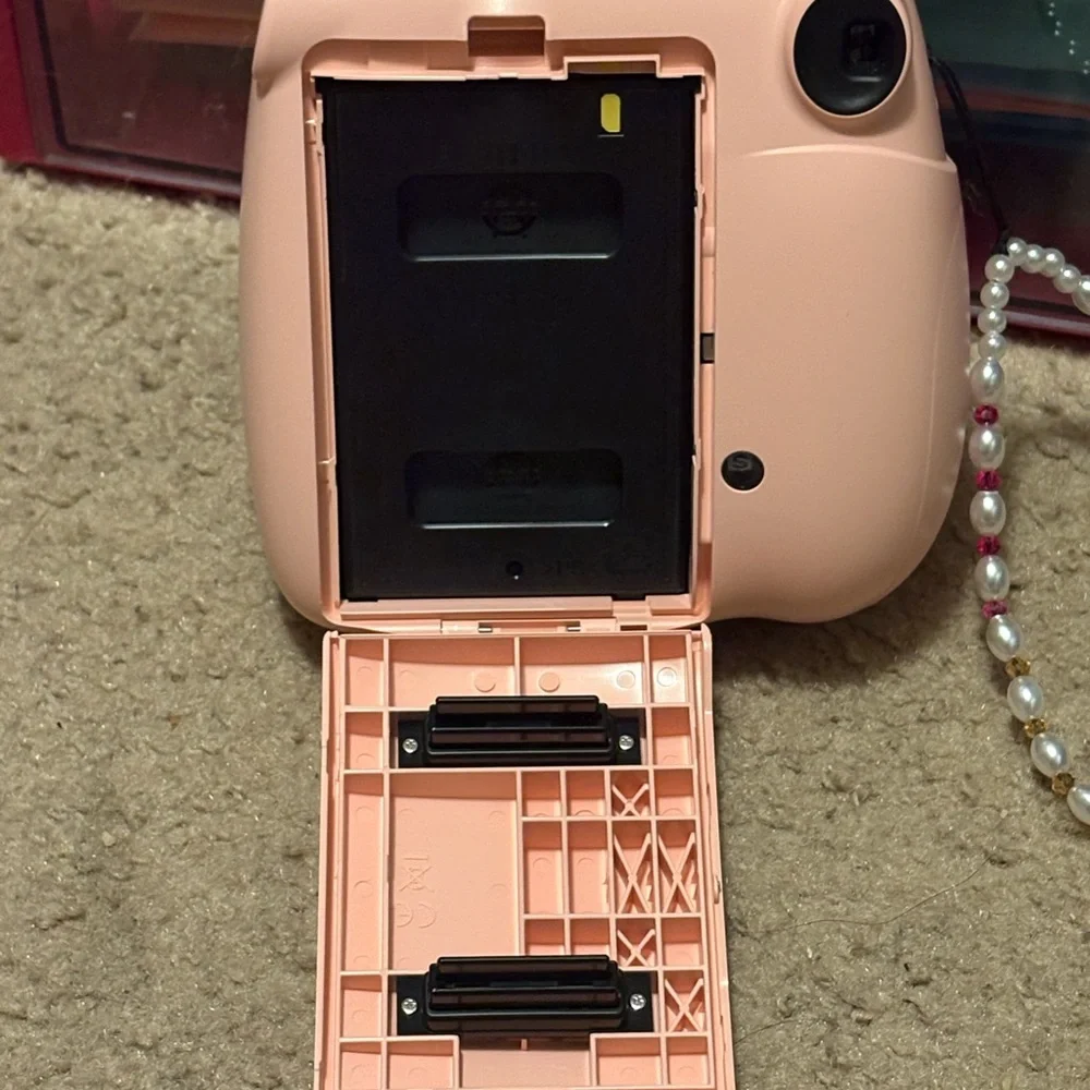 NWOT instax mini 7+ pink camera with a beaded lanyard (uses 4 AA batteries)